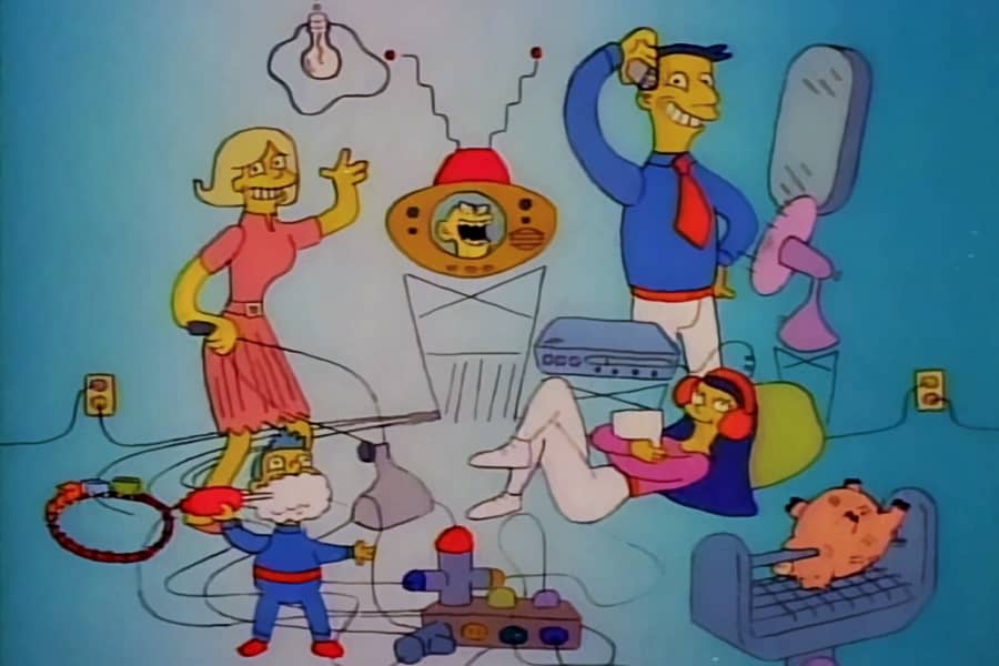 a family surrounded by lots of electronics