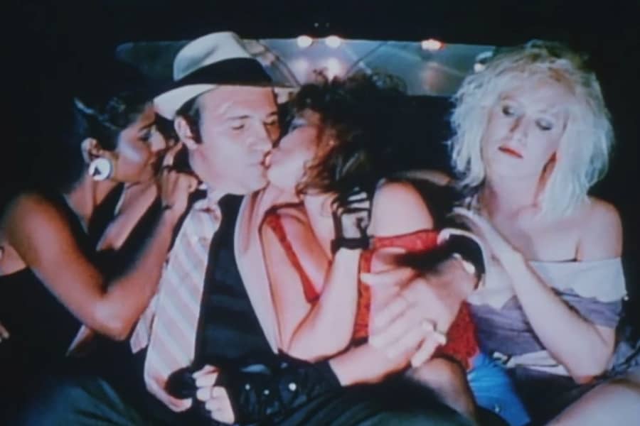 Nunzio with three women in his car, he’s kissing one of them