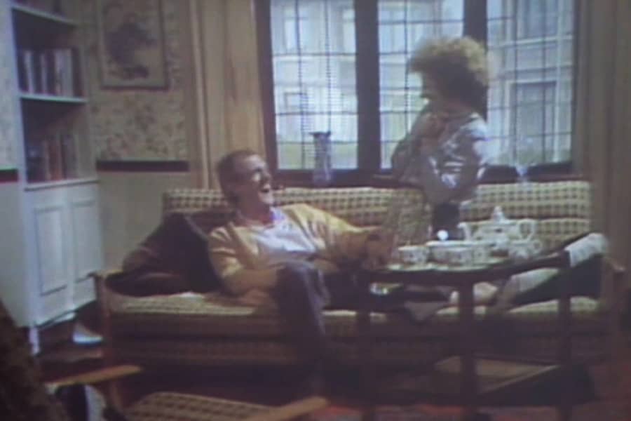 man and woman laughing on a couch