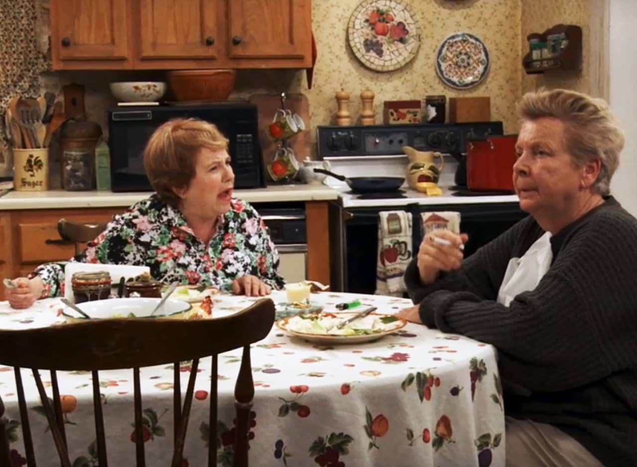 Bonnie Kelly at the kitchen table, yelling at Mrs. McDonald