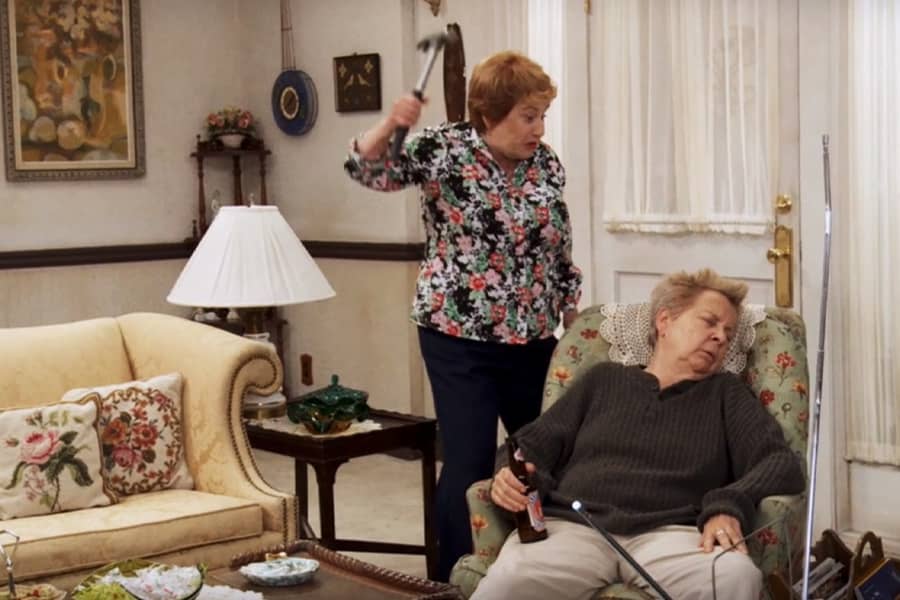 Bonnie lifting a hammer above Mrs. McDonald’s sleeping head