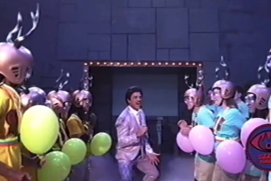the host pumps up two teams of kids in colorful shirts and gold helmets