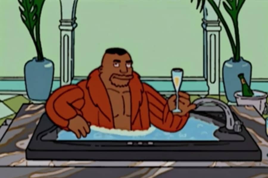 Drederick Tatum wearing a fur coat and drinking champagne in a nice bathtub