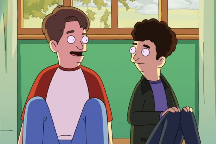 two boys sit talking beneath a window