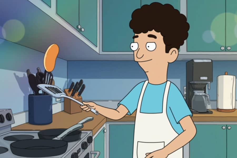 curly-haired boy making pancakes