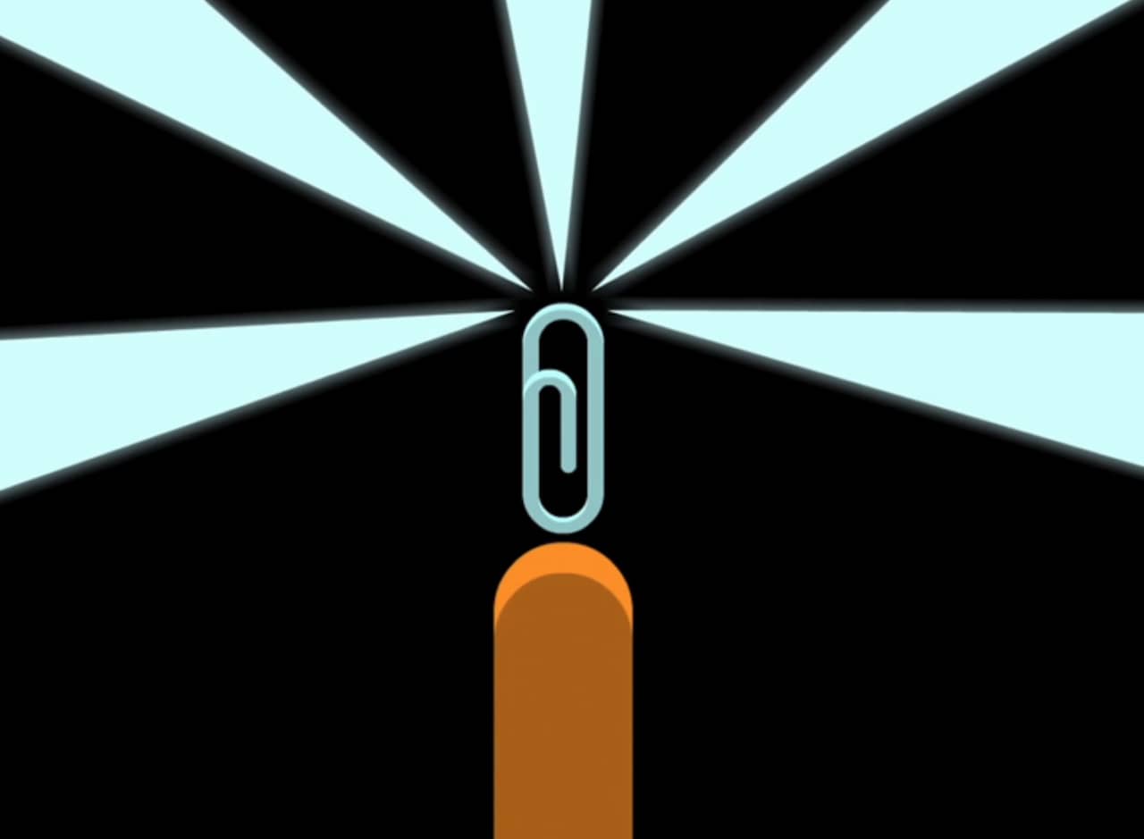 hand holding up a glowing paperclip
