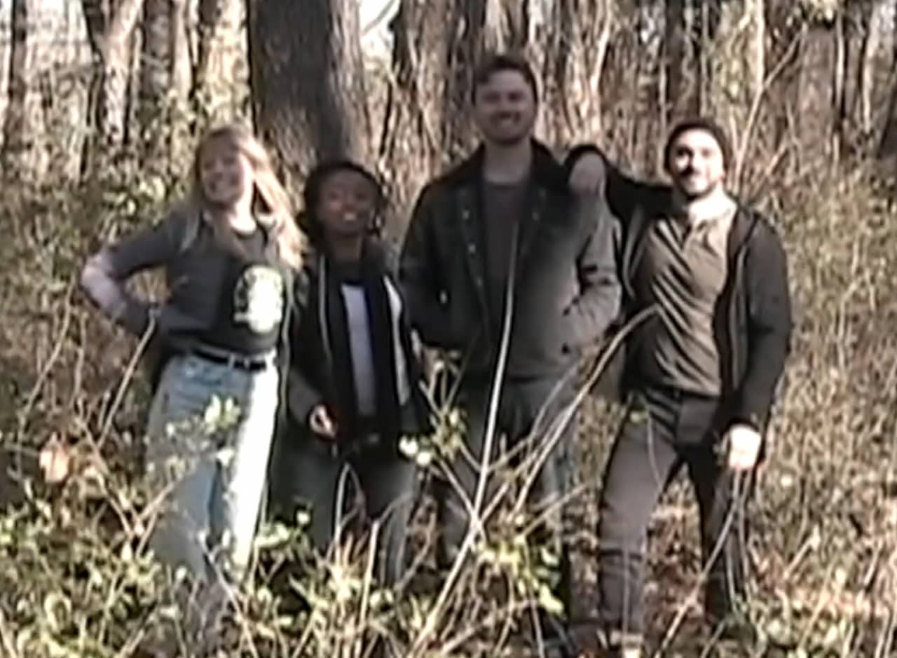 the Paranormal Paranoids team pose for a photo in the woods