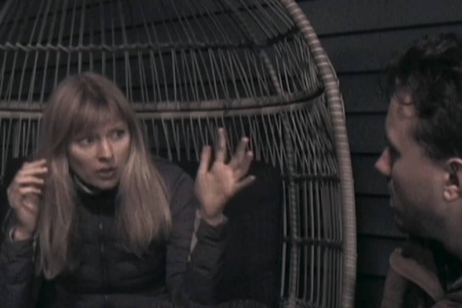 Riley talking in a porch chair