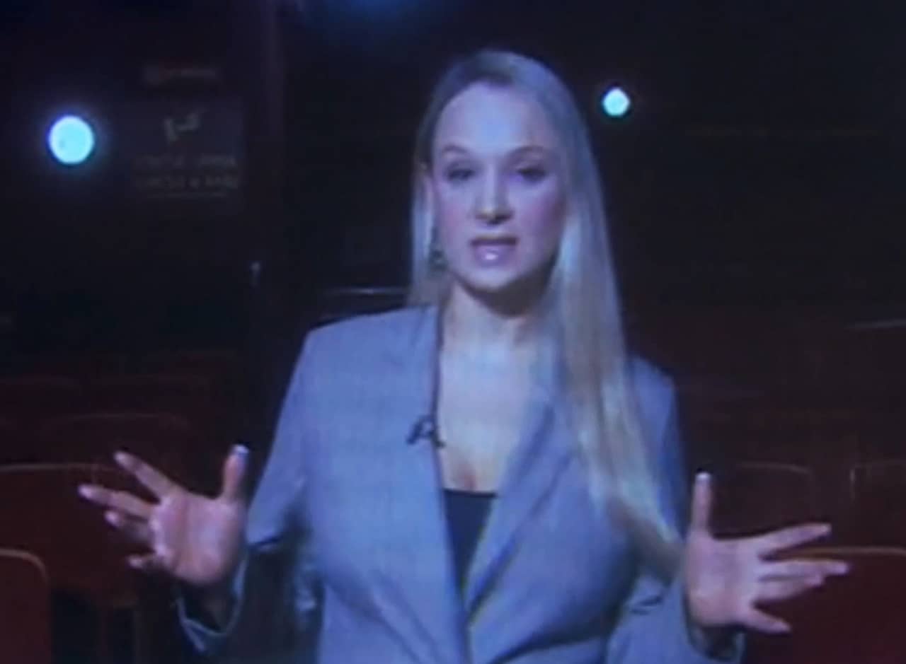 blonde woman host in an old theatre