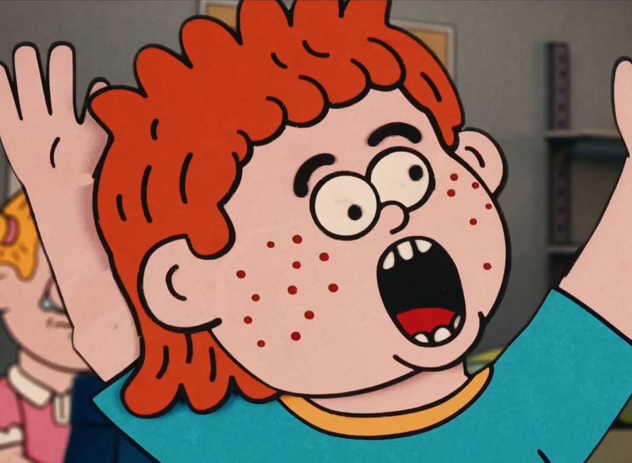 freckled, red headed boy yells with his hands in the air