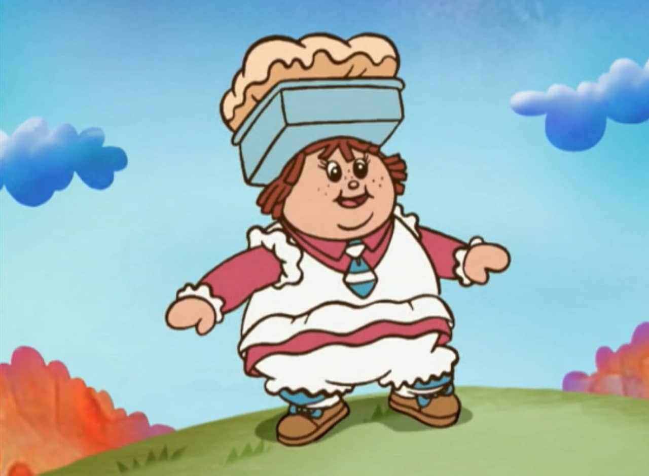 Paula Poundcake, a round girl with red hair and a pound cake hat