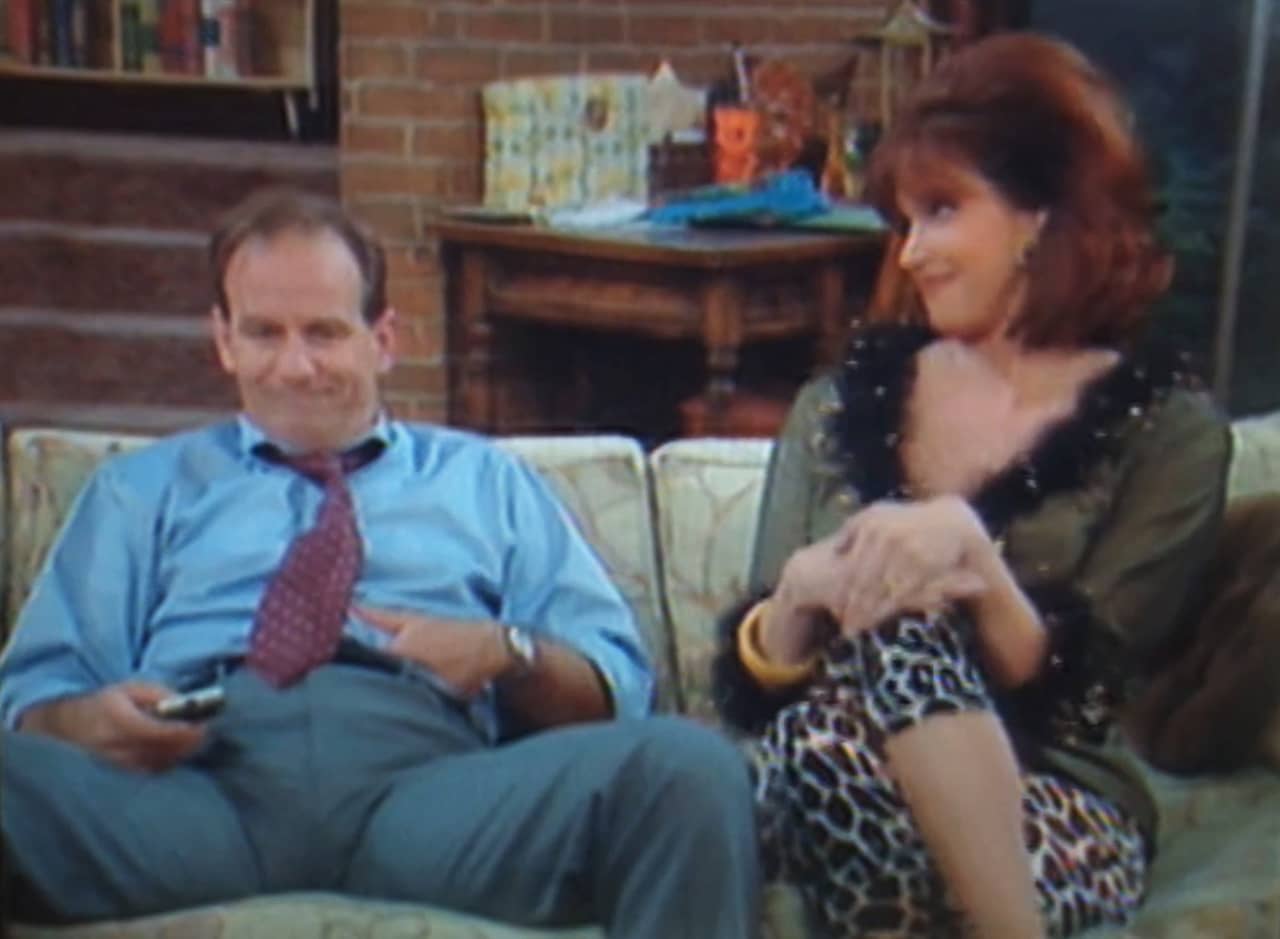 Mel and his wife Patty on the couch, they look like Al and Peggy Bundy