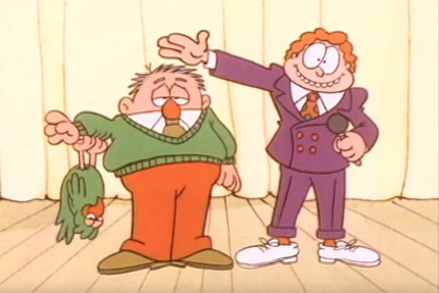 host with a man in a green sweater with a similarly green bird hanging from his arm