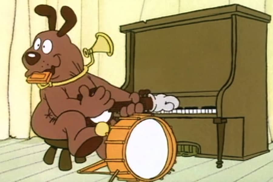 a one-man-band dog playing multiple musical instruments