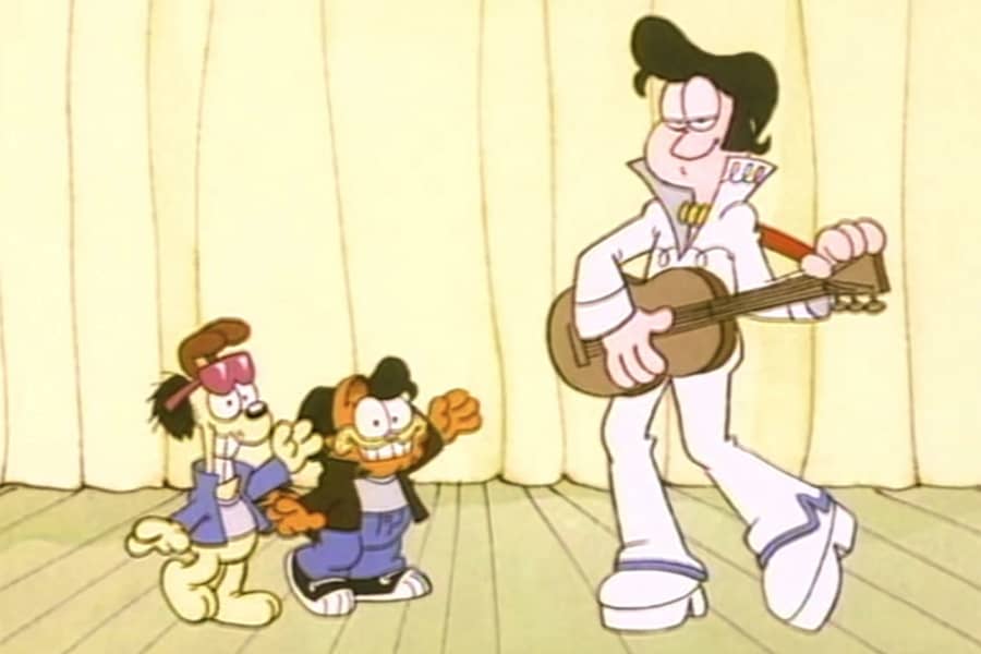 a man dressed as Elvis with a dancing cat and dog