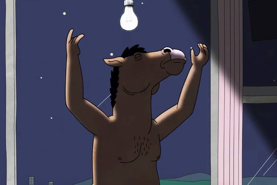 a nude Philbert changes a lightbulb