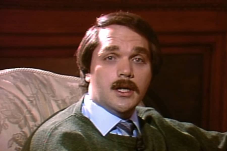 Steve Pising talking in an armchair