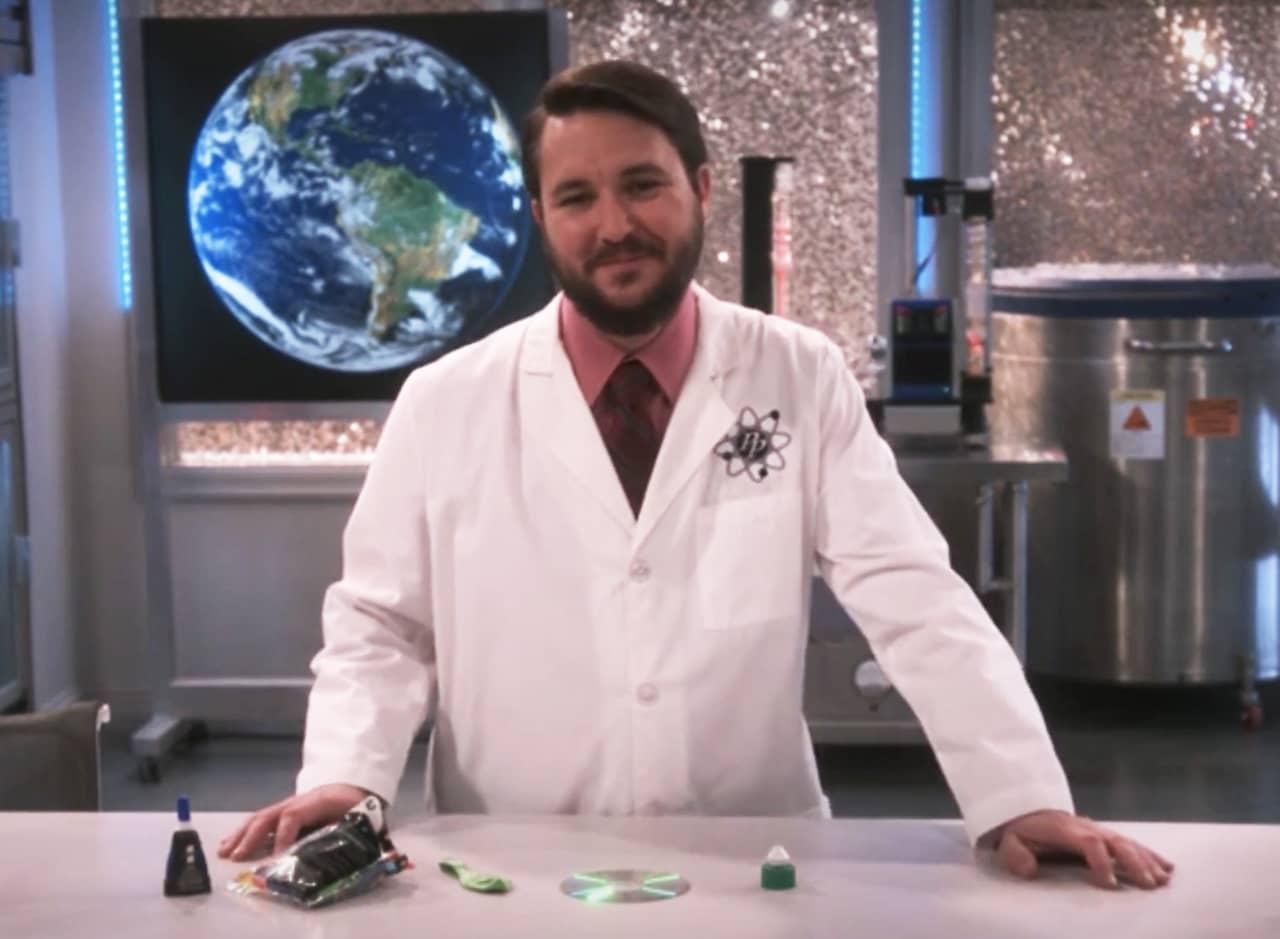 Wil Wheaton in a lab coat on a science lab set