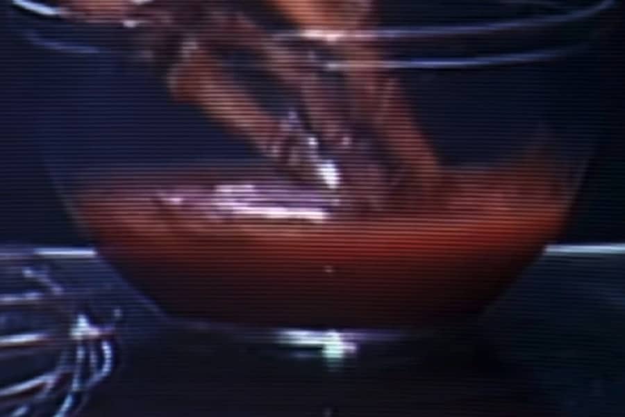 skeleton hand dipping into a bowl of sauce
