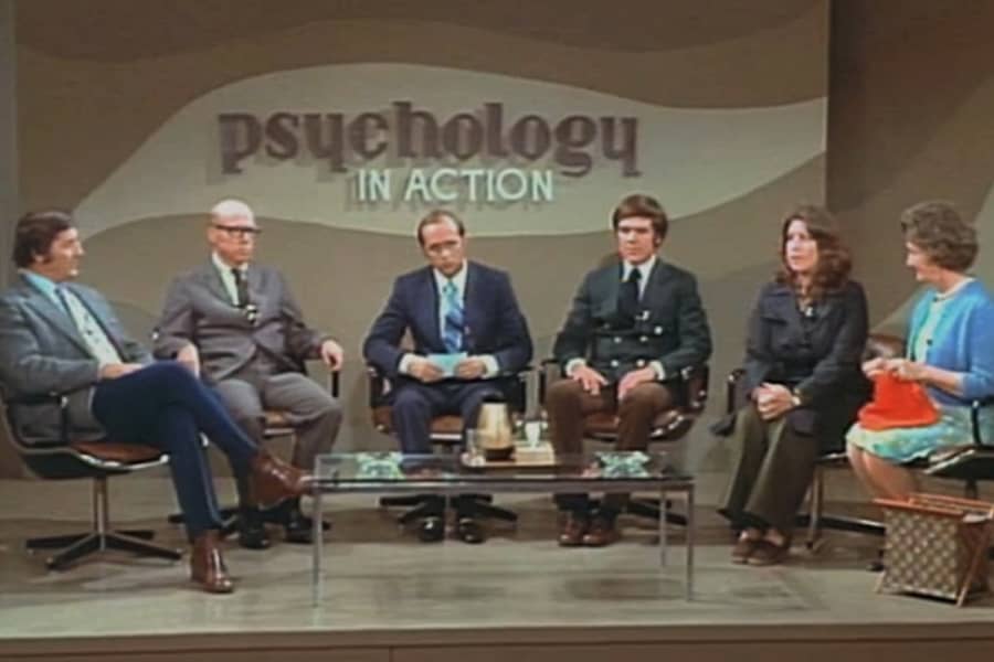 Hartley in a chair circle with five guests