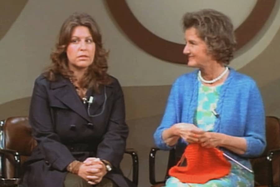 two women: one brunette and an older one knitting