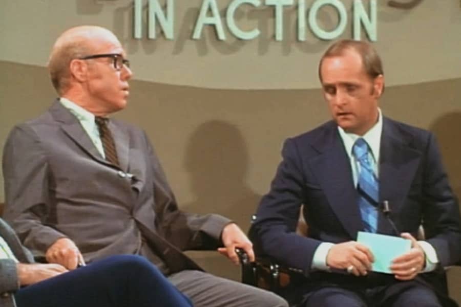 Hartley speaks with a man with glasses