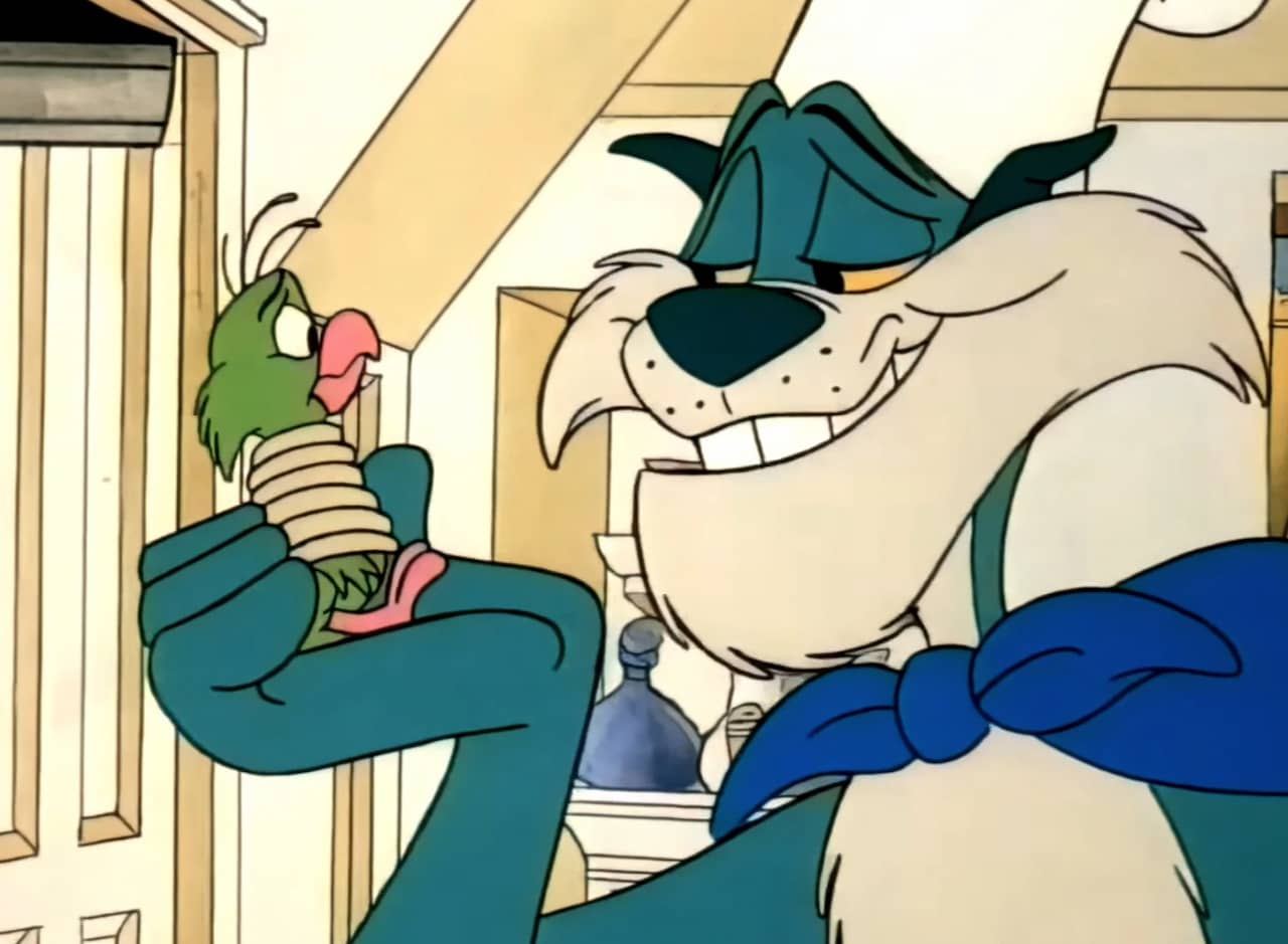 Grunge the cat in a chef’s hat holding Pudgy the parrot who is tied up