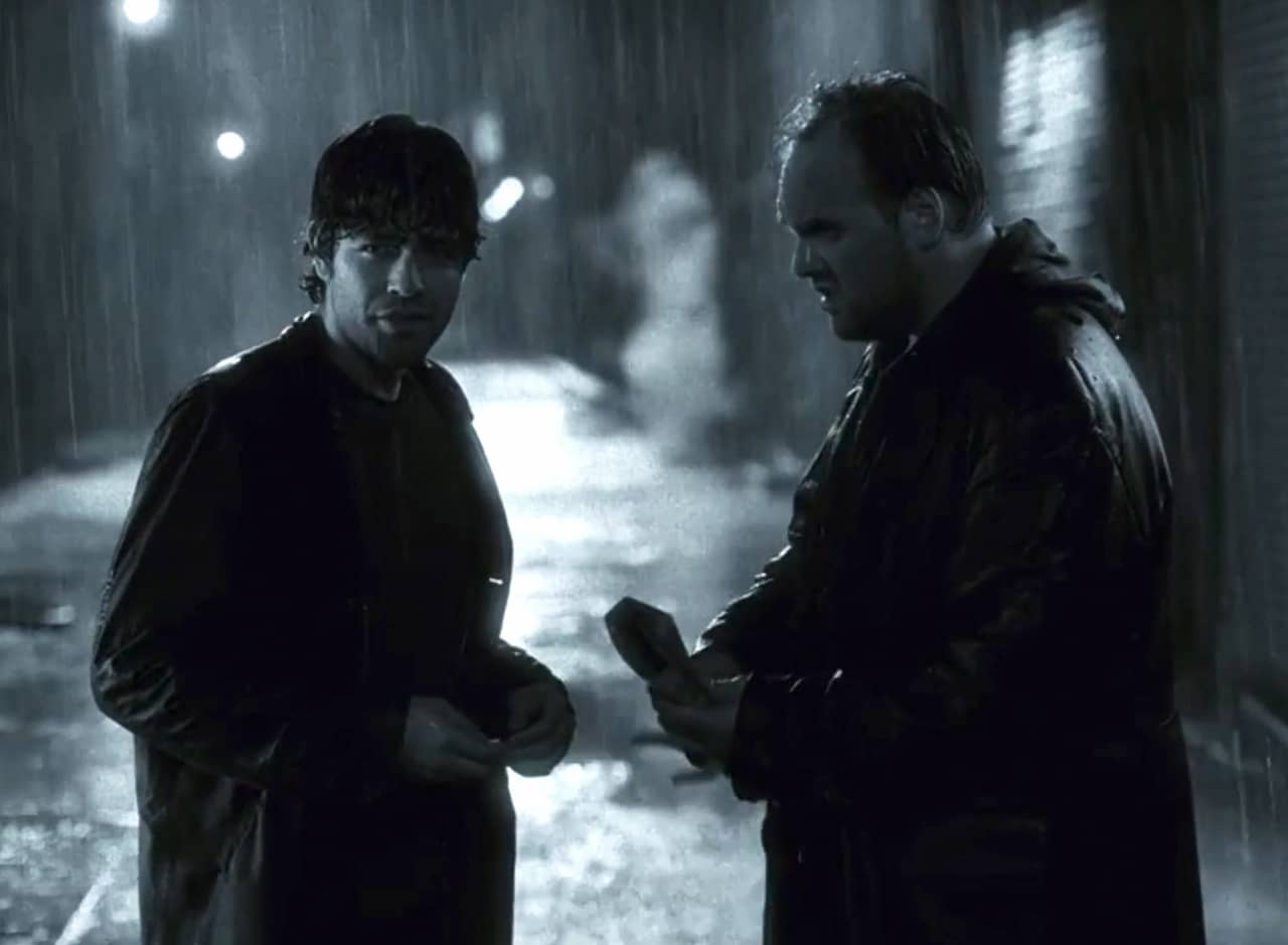 Chase and Suplee meeting in an alley in the rain