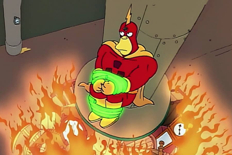 Radioactive Man is tied up on a platform as a fire rages below him