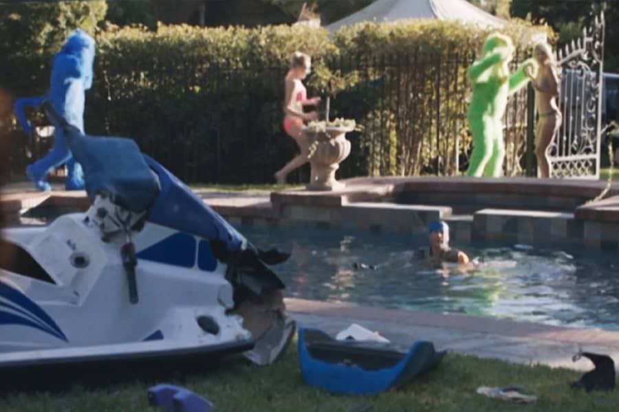 colorful panthers chasing women around a pool