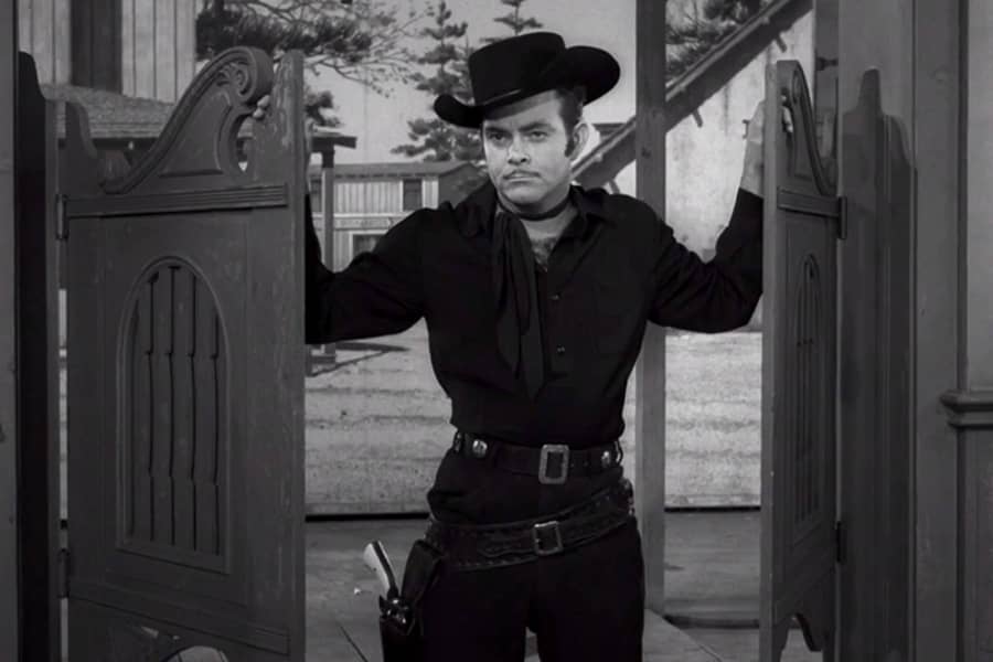 man in black entering the saloon
