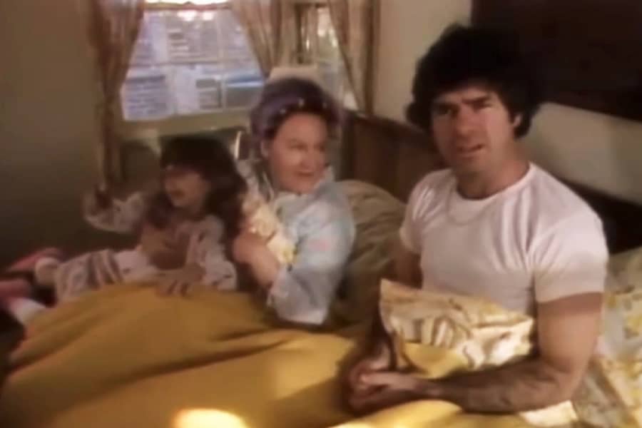 a family waking up in bed