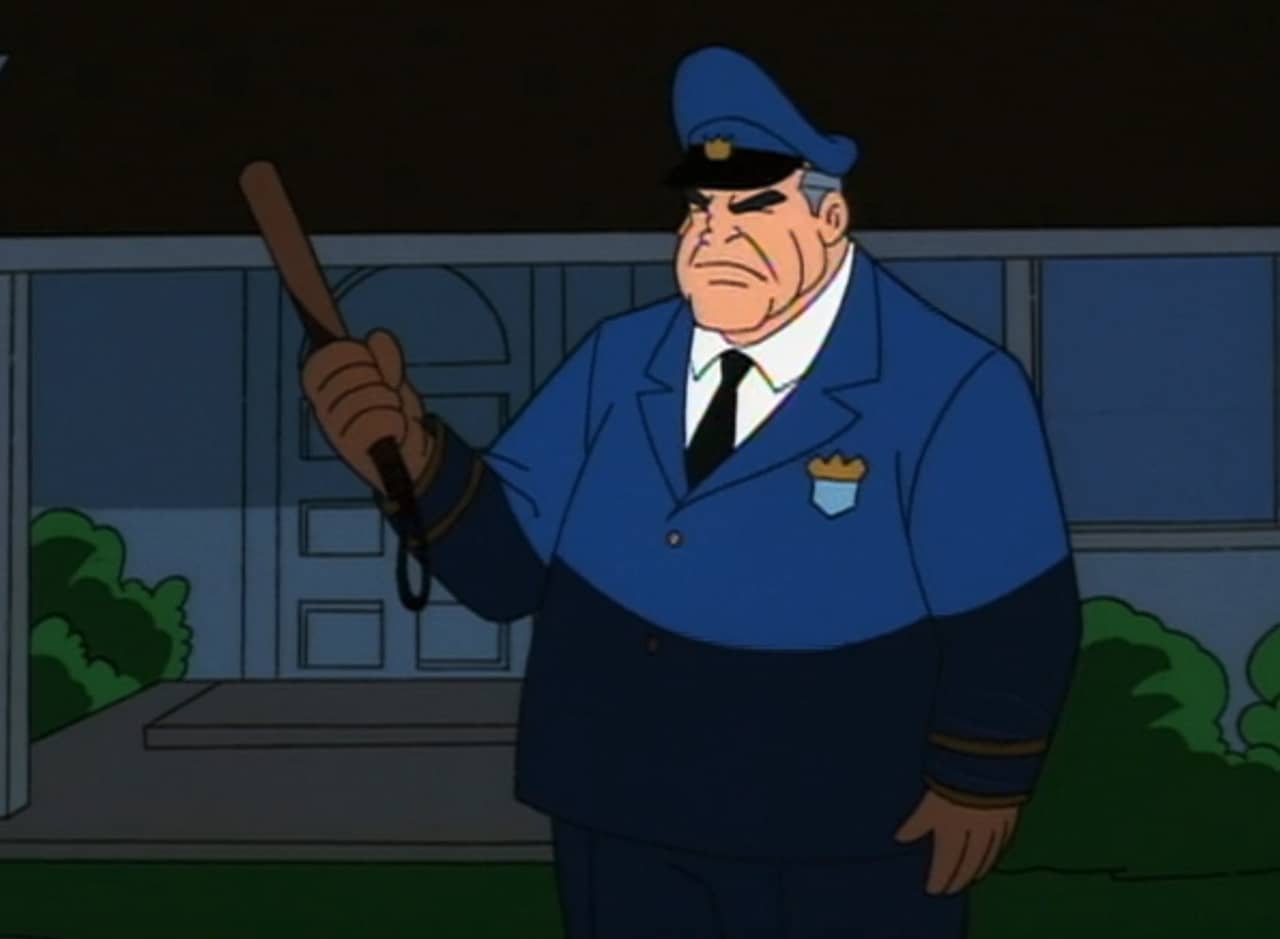 cop standing in front of a house