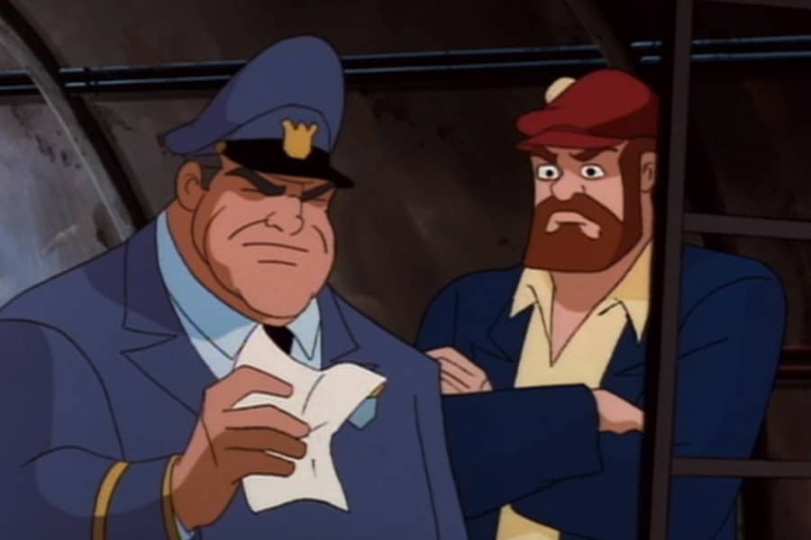cop looking at a piece of paper next to a red-headed bearded man in a sewer