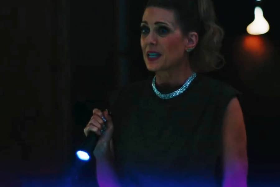 divorcée in the dark, holding a flashlight and wearing a thick diamond necklace