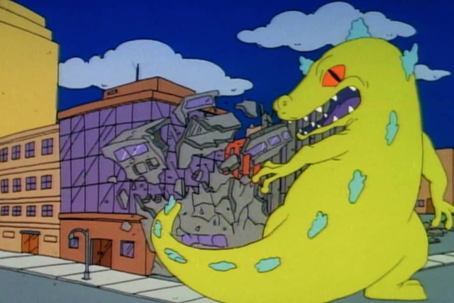 Reptar destroys a building with his tail