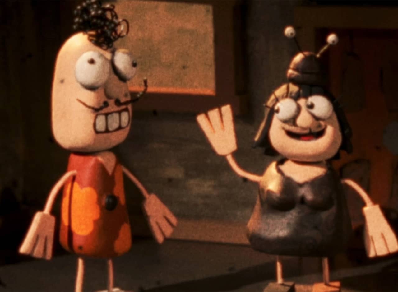 two model characters, one of Grace (a woman wearing a snail cap), and a man with curly hair and mustache