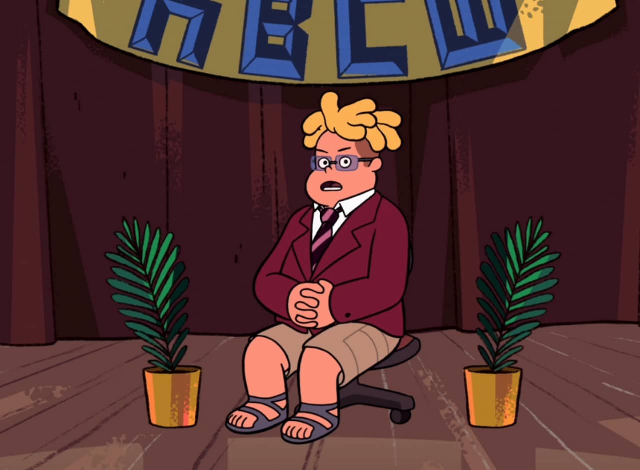 Ronaldo Fryman in a blazer, on a chair, between two ferns