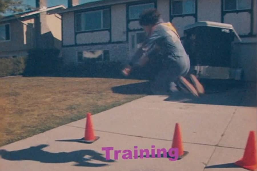 Rod jumping over some orange parking cones with “Training” text below