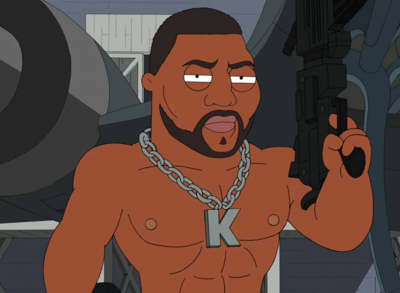 Quinton Jackson as Kunta Kinte 9000 wearing a K chain and holding a machine gun