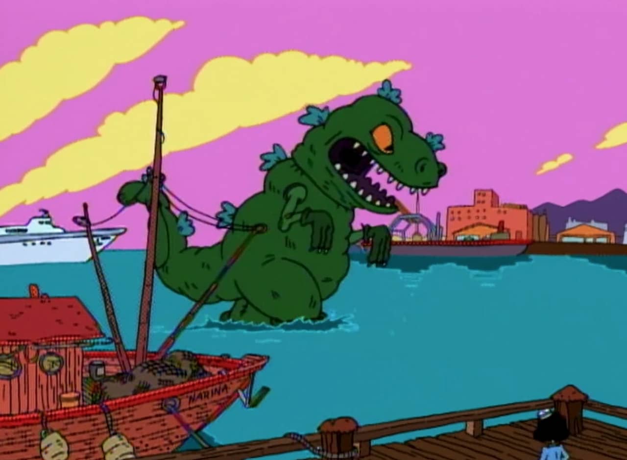 Reptar, a giant t-rex, walks in a harbor toward the city