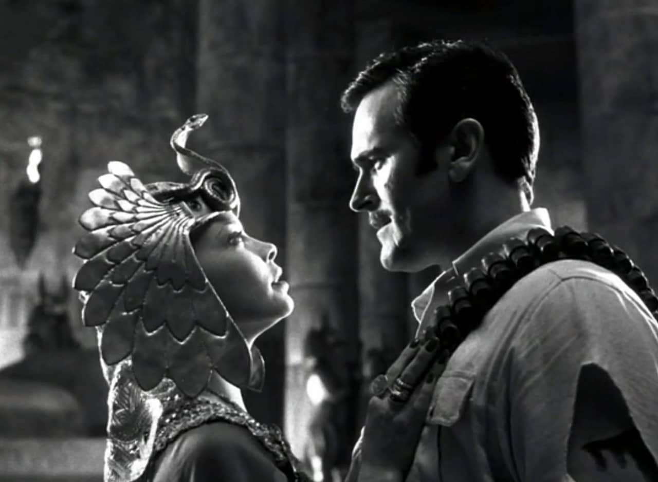 Sandra Sinclair as Emily in Egyptian headdress looking at Brett Armstrong’s Roland