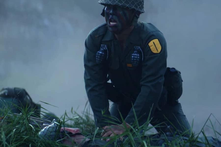 a soldier does chest compressions on a fallen soldier