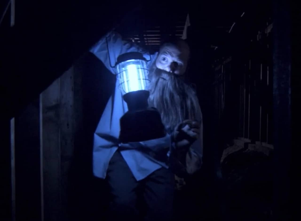 Tobias Funke as George Bluth hiding out in a dark crawl space with a lantern