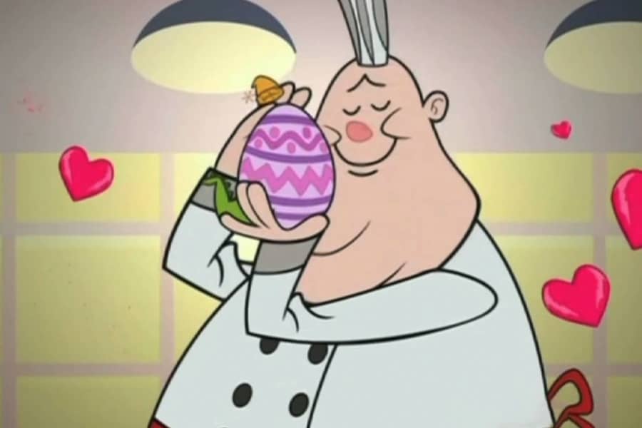 the chef hugging Crocco the egg with hearts surrounding them