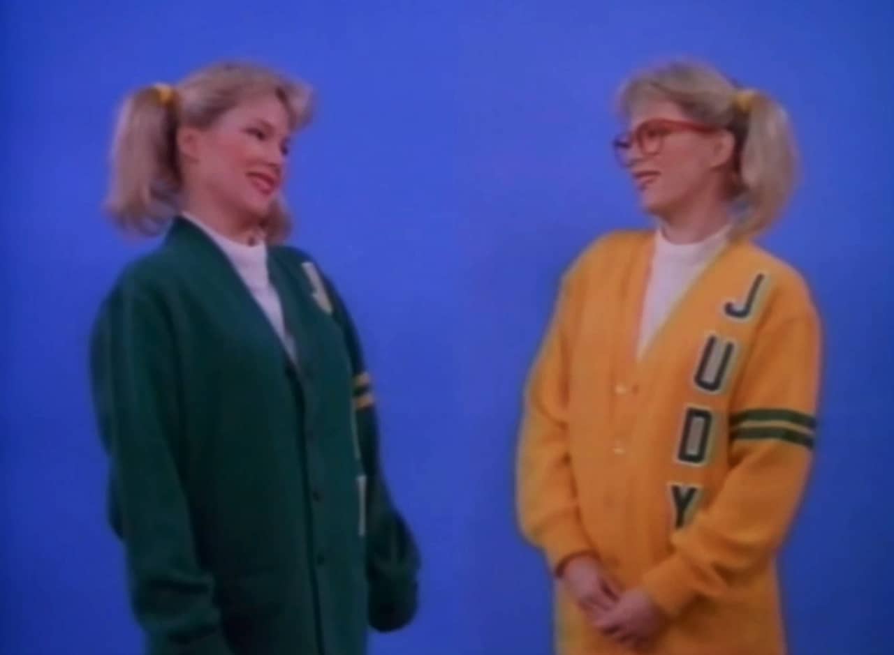 Stephanie Vanderkellen as twins Jody and Judy, each in a sweater with their names on them
