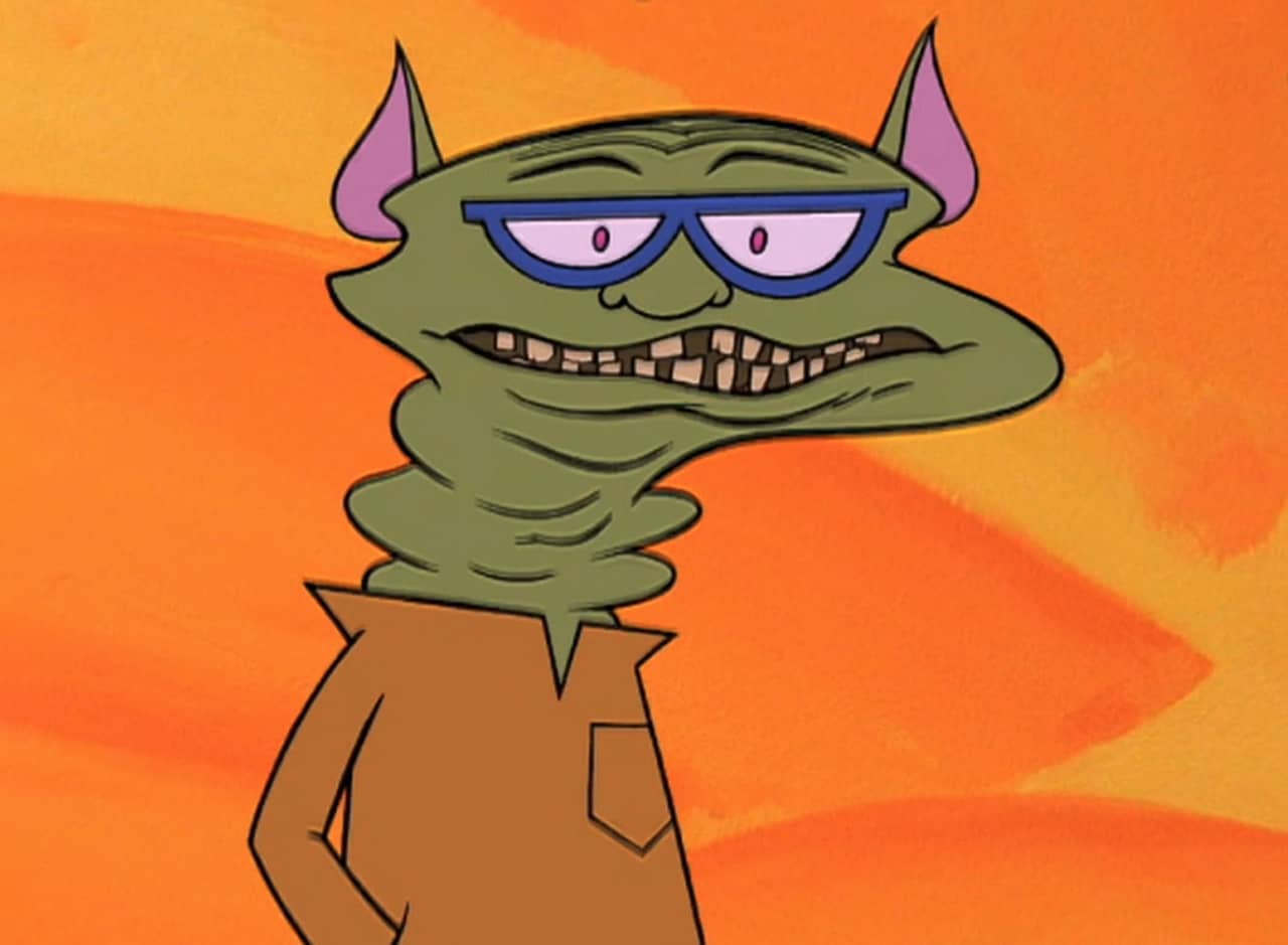 Señor Science, a green goblin-like guy, with big teeth and blue-rimmed glasses