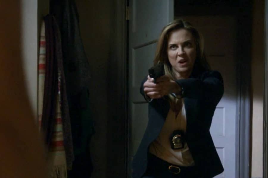 woman detective bursts through the door pointing a gun