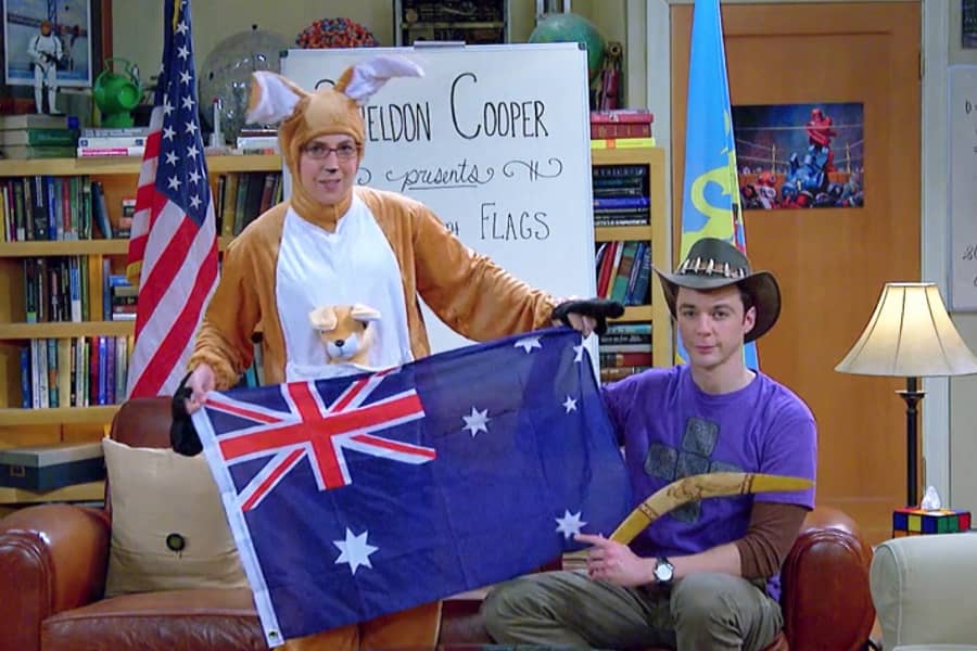 Cooper wearing a Crocodile Dundee hat and holding a boomerang with Fowler dressed as a kangaroo holding the Australia flag