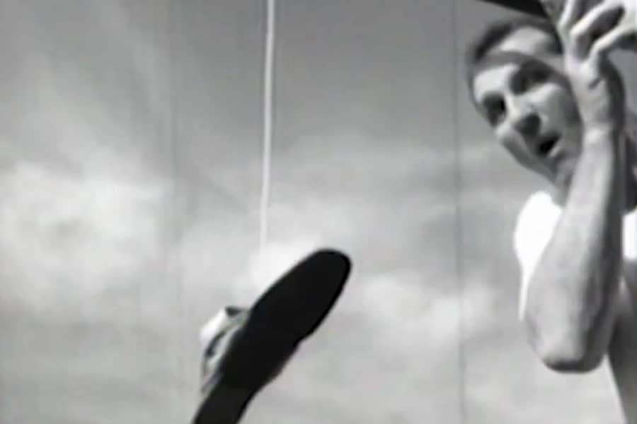 Al Bundy with a pole dangling a sandal in the air